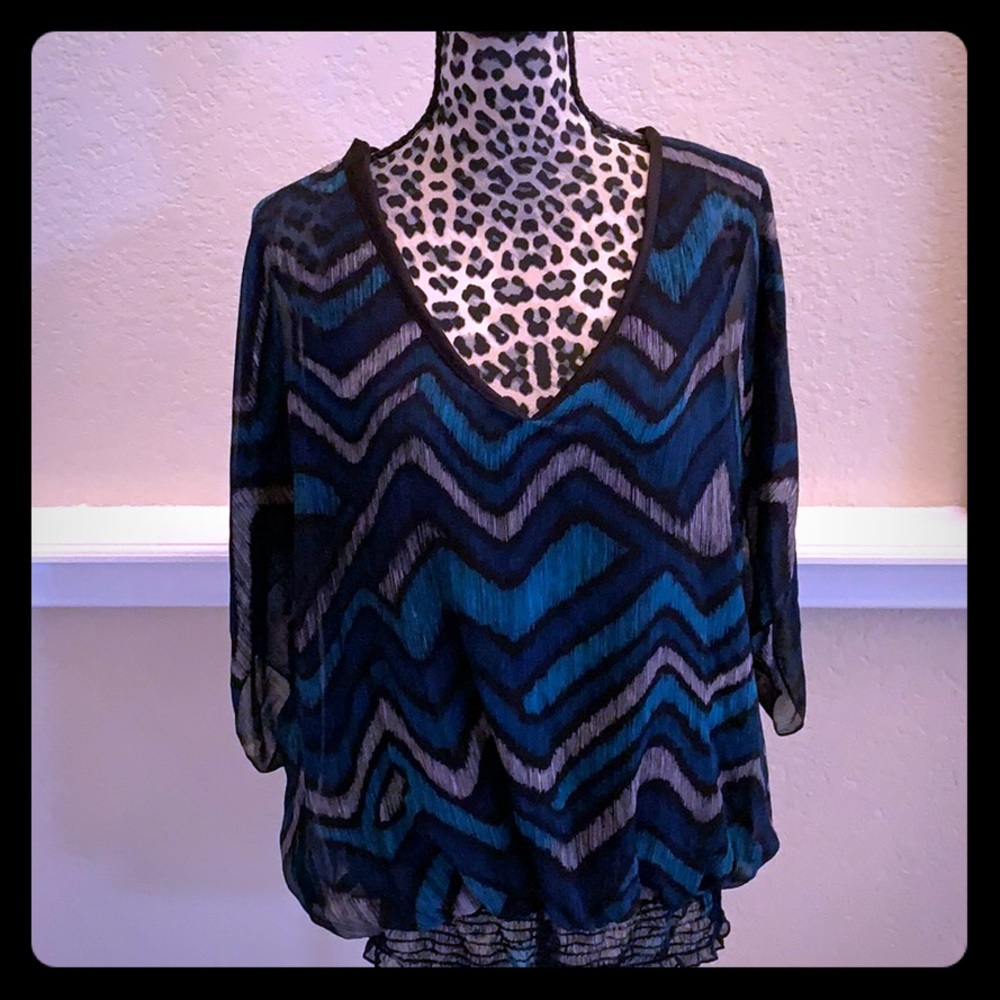 Chevron black and teal blouse with winged sleeves.